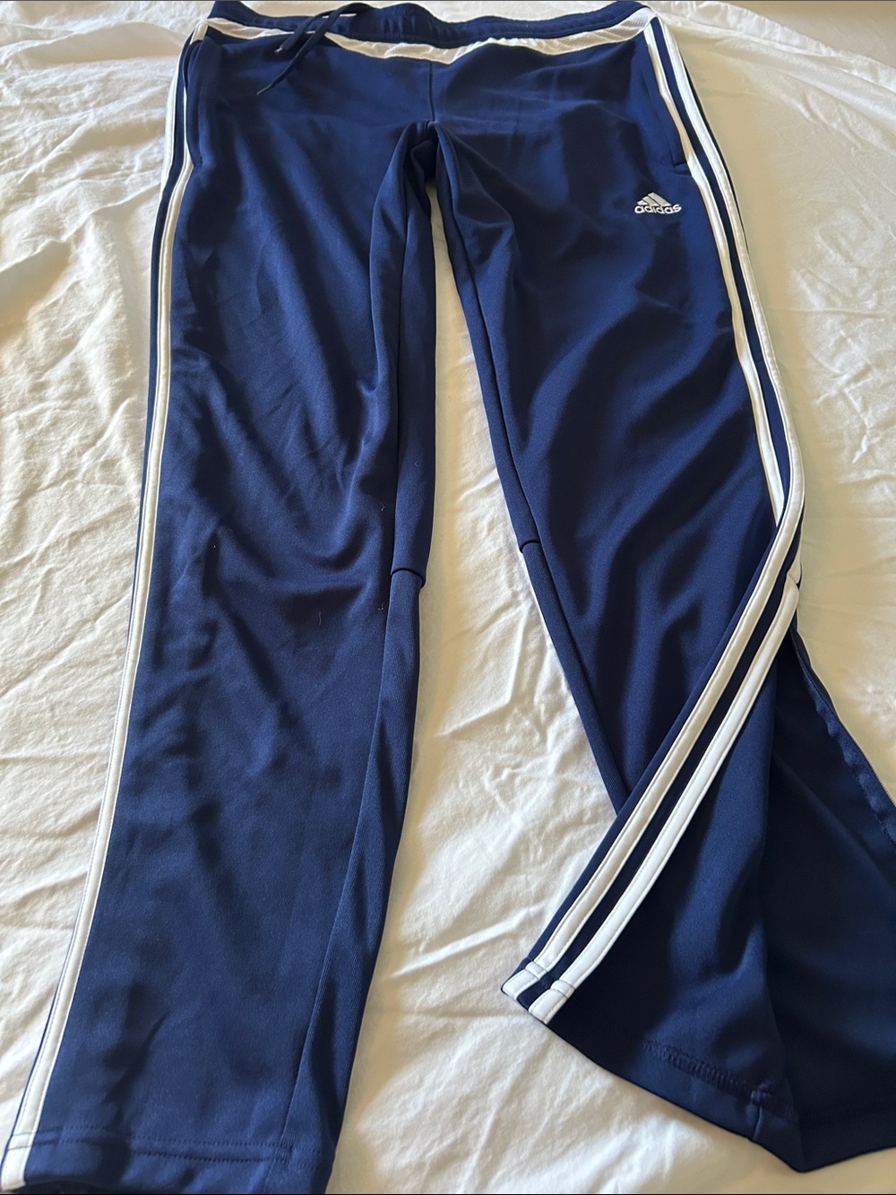 adidas Navy Blue women’s Track Pants with White Side Stripes and ankle zippers.